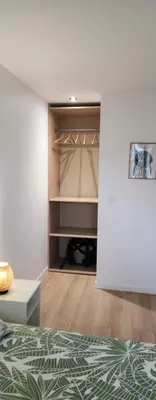 a bedroom with a bed and a closet at Le maillot VII in Castres