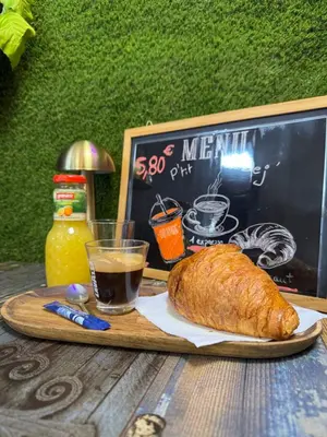 a tray with a loaf of bread and a glass of coffee at La perle limouxine -Studio in Limoux