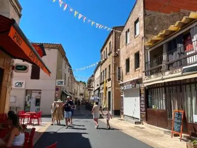 a group of people walking down a city street at Studio 3 pers à Gruissan - Vue Port - Parking - Climatisation Mobile - FR-1-796-89 in Gruissan