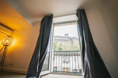 a window with a view of a castle at Face à la cité, Terrasse Et Climatisation - AE in Carcassonne