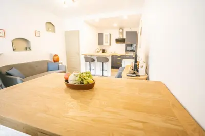 a bowl of fruit on a wooden table in a living room at Face à la cité, Terrasse Et Climatisation - AE in Carcassonne