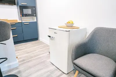a kitchen with a chair and a small refrigerator at Face à la cité, Terrasse Et Climatisation - AE in Carcassonne