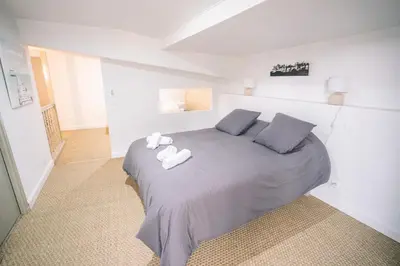 a bedroom with a bed with two towels on it at Face à la cité, Terrasse Et Climatisation - AE in Carcassonne