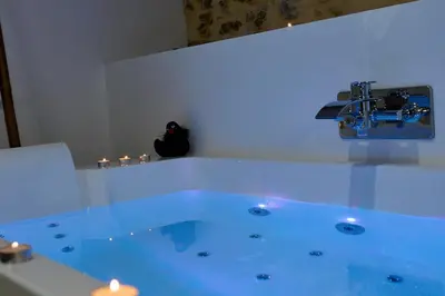 a bathroom with a tub with a water fountain at Love room évasion in Tuchan