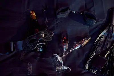 a table with spoons and a bottle of wine and glasses at Love room évasion in Tuchan