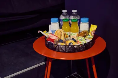 a basket of food and drinks on a red table at Love room évasion in Tuchan