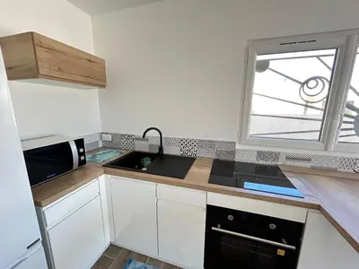 a kitchen with a sink and a microwave at Rubis in Lapalme