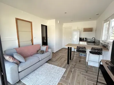 a living room with a couch and a table at Rubis in Lapalme