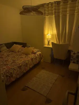a bedroom with a bed and a desk and a chair at La parenthèse in Pamiers