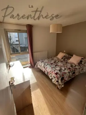 a bedroom with a bed and a sign that reads far centimeters at La parenthèse in Pamiers