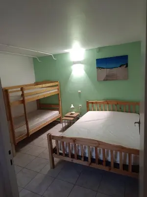 a bedroom with two bunk beds and a light on the wall at Appartement Salles d 'Aude in Salles-d'Aude