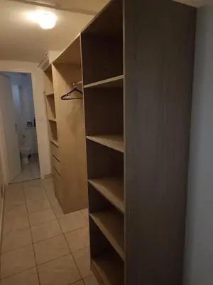 a closet with wooden shelves in a room at Appartement Salles d 'Aude in Salles-d'Aude