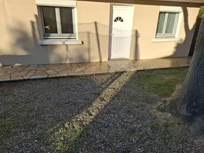 a house with a white door and a tree at Appartement Salles d 'Aude in Salles-d'Aude