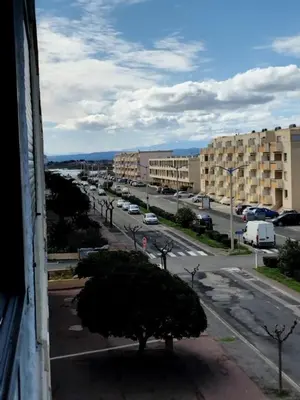 a view of a city street with buildings and a tree at STUDIO Bis - PLAGE in Port-la-Nouvelle