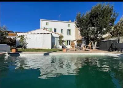 a house and a swimming pool in front of a house at Rêve Capestanais - B&B avec Piscine in Capestang