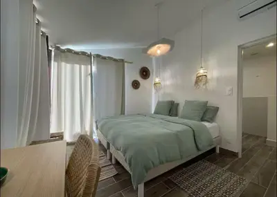 a bedroom with a large bed and a window at Rêve Capestanais - B&B avec Piscine in Capestang