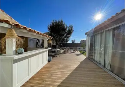 a balcony of a house with a wooden deck at Rêve Capestanais - B&B avec Piscine in Capestang