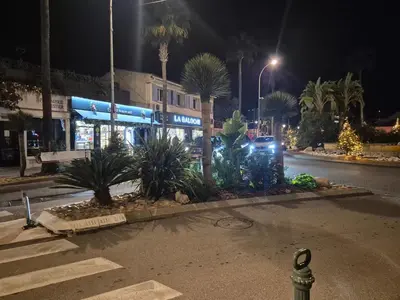 a street at night with a car parked in front of a store at Appartement in Carcassonne