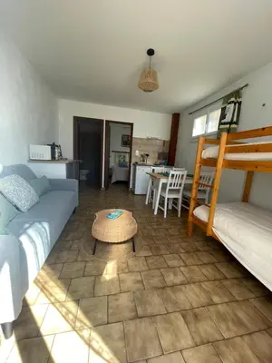 a living room with a couch and a bed and a table at Entre Mer et Vigne Caves in Caves