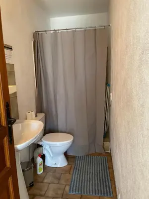 a bathroom with a white toilet and a sink at Entre Mer et Vigne Caves in Caves