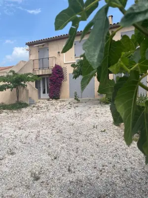 a house with a gravel yard in front of it at L'esprit Garrigue Caves in Caves