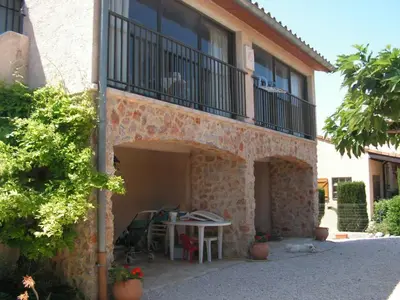 a building with a table and a balcony at L'esprit Garrigue Caves in Caves