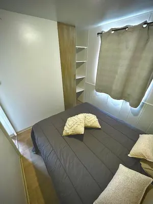 a bedroom with a bed with a pillow on it at Tiny house Port la Nouvelle in Port-la-Nouvelle