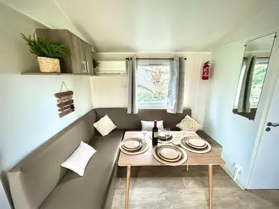 a small table with plates on it in a caravan at Tiny house Port la Nouvelle in Port-la-Nouvelle