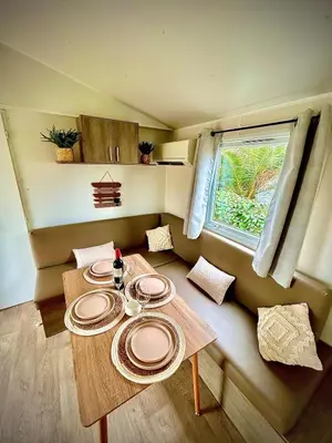 a table with plates on it in a room at Tiny house Port la Nouvelle in Port-la-Nouvelle