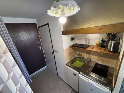 a small kitchen with a sink and a microwave at Appartement Studio-Cabine PORT-LA NOUVELLE PN290-074 in Port-la-Nouvelle