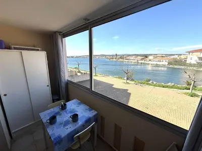 a room with a window with a view of the water at Appartement Studio-Cabine PORT-LA NOUVELLE PN290-074 in Port-la-Nouvelle
