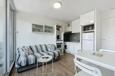 a living room with a couch and a table at Le Cordier - Apartment near the harbor in Gruissan
