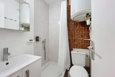 a bathroom with a shower and a toilet and a sink at Le Cordier - Apartment near the harbor in Gruissan
