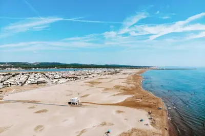 an aerial view of a beach with houses and the water at Le Cordier - Apartment near the harbor in Gruissan