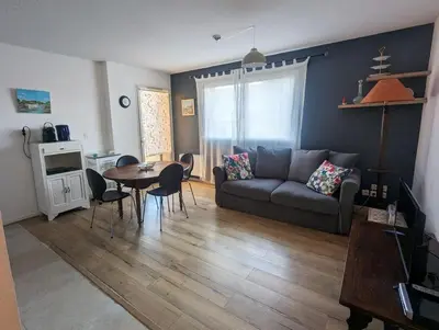 a living room with a couch and a table at Escapade à Nailloux in Nailloux