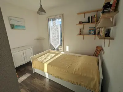 a bedroom with a bed in a room with a window at Escapade à Nailloux in Nailloux