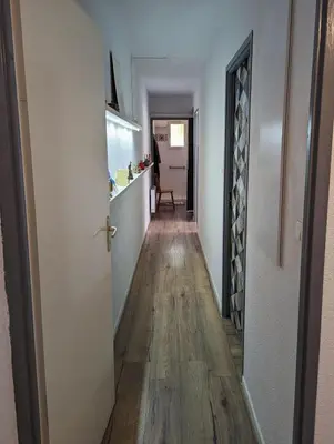 a hallway leading to a living room and a kitchen at Escapade à Nailloux in Nailloux