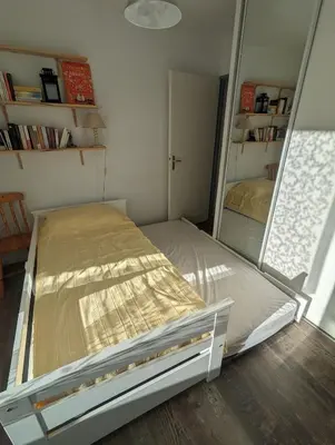 a bedroom with a bed and a large mirror at Escapade à Nailloux in Nailloux
