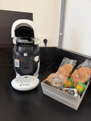 a coffee maker and a box of bread on a table at Studio design hypercentre Gare & espresso offert in Castelnaudary