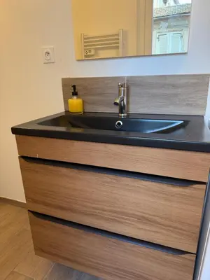 a bathroom sink with a soap dispenser on it at Studio design hypercentre Gare & espresso offert in Castelnaudary