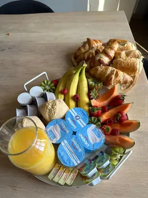 a plate of food on a table with bread and fruit at Au cocon des corbières - Élégance in Lézignan-Corbières