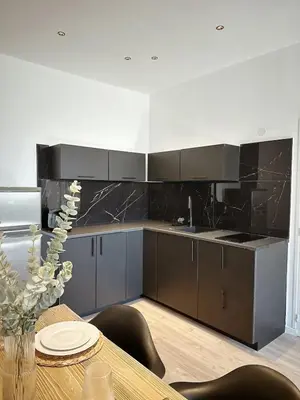 a kitchen with a wooden table with a dining room at Au cocon des corbières - Élégance in Lézignan-Corbières