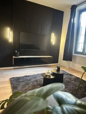 a living room with a large flat screen tv at Au cocon des corbières - Élégance in Lézignan-Corbières