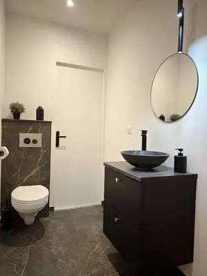 a bathroom with a sink and a toilet and a mirror at Au cocon des corbières - Élégance in Lézignan-Corbières