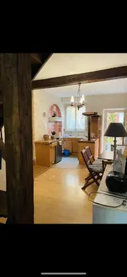 a living room with a kitchen and a dining room at Appartement au cœur de Mirepoix in Mirepoix