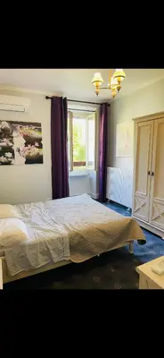 a bedroom with a bed and a window at Appartement au cœur de Mirepoix in Mirepoix