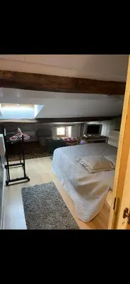 a bedroom with a bed and a table in it at Appartement au cœur de Mirepoix in Mirepoix