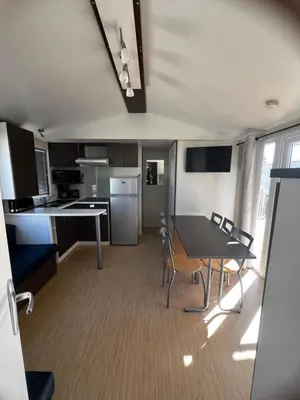 a room with chairs and a table and a couch at Mobil Home 014 climatisé -camping Novela-3Ch in Port-la-Nouvelle