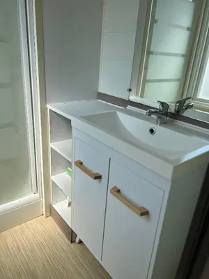a bathroom with a white sink and a mirror at Mobil Home 014 climatisé -camping Novela-3Ch in Port-la-Nouvelle