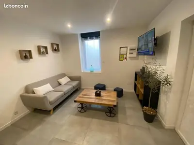 a living room with a couch and a coffee table at Gîte la Cave in Quarante